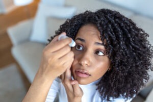 Woman uses eye drops for dry eye